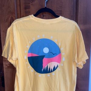 Nature Backs comfort colors short sleeve tee with cliff sunset in light yellow